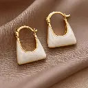 Iridescent Gold Hoop Earrings on Taupe (1).webp