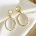 Elegant Oval Dangle Earrings with White Cat Eye Stone in Gold Bezel